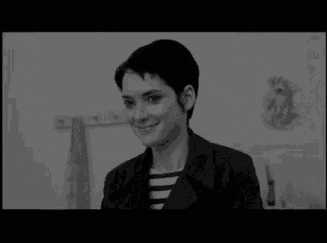 a black and white photo of a woman with short hair .