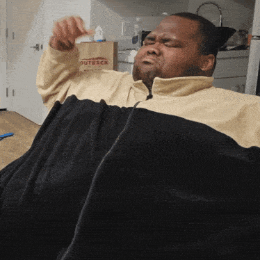 a man is laying on a couch with a bag that says outback in the background