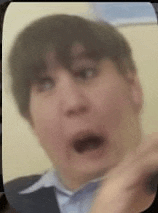 a close up of a person 's face with a surprised look on it .