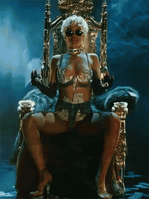 a woman is sitting on a throne with a bunch of money around her waist