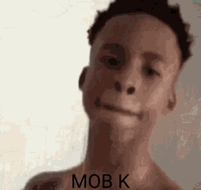 a close up of a man 's face with the words mob k written on it