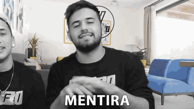a man in a black shirt with the word mentira on his chest