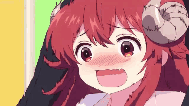 a girl with red hair and horns is making a face