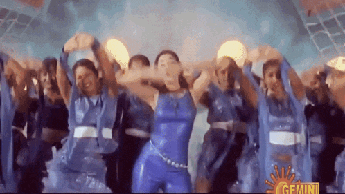 a group of people are dancing in front of a sun that says gemini
