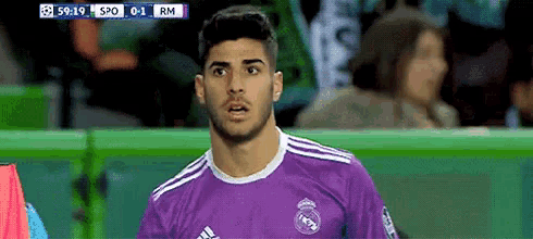 a soccer player wearing a purple jersey is looking at the camera .