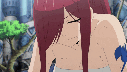 a girl with red hair has a tattoo on her arm that says " fairy tail "