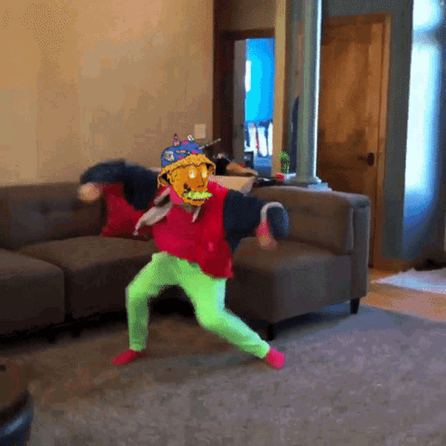 a person is dancing in a living room with a cartoon character on their face