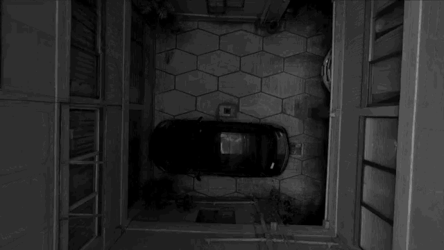 a car is parked in the middle of a courtyard