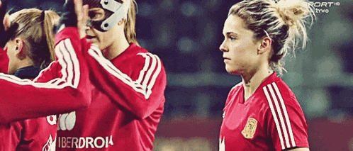 a group of female soccer players wearing red jerseys that say iberdrol on the back