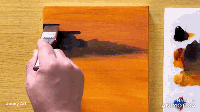a person is painting on a canvas with the words made in animatica at the bottom