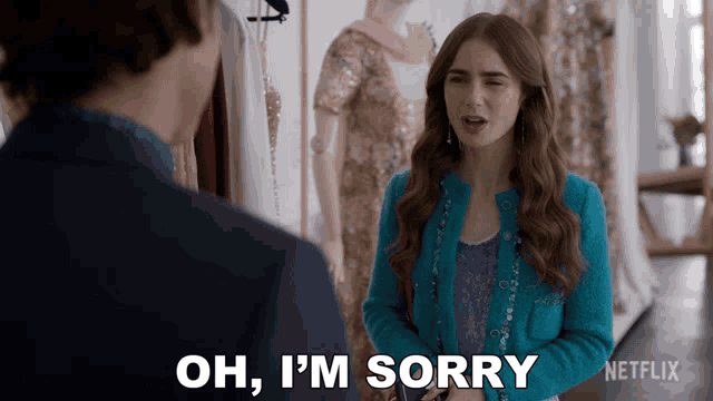 a woman in a blue jacket says oh i 'm sorry in front of a man in a suit