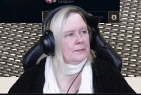 a woman wearing headphones is sitting in front of a screen that says league +