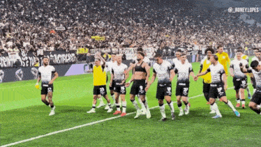 a group of soccer players on a field with a banner behind them that says ' ronelylopes '