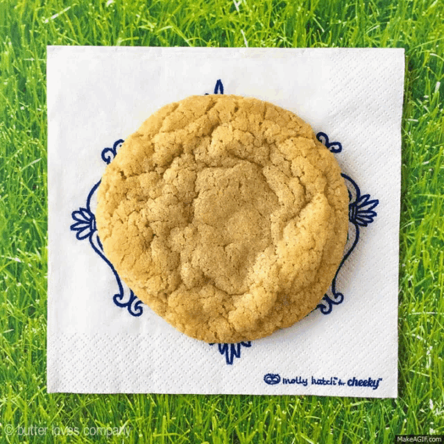 a cookie is sitting on a napkin that says molly hates it cheeky