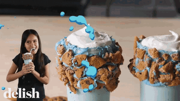 a woman drinking a milkshake with the word delish on the bottom right