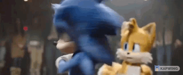 sonic the hedgehog and tails the fox are standing next to each other in a crowded room .
