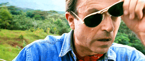 a man wearing sunglasses and a denim shirt
