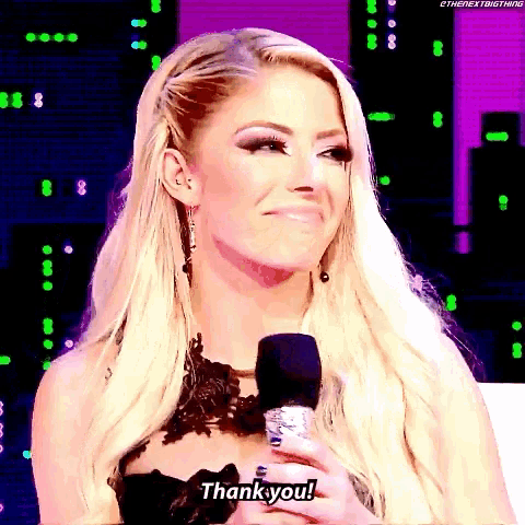 a woman in a black dress is holding a microphone and saying thank you .