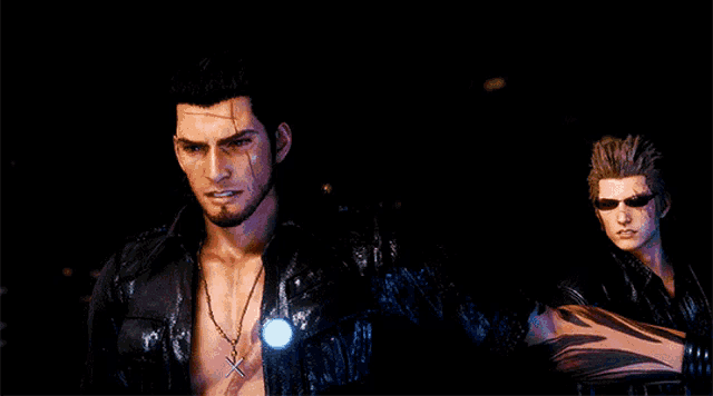 two men standing next to each other with one wearing a necklace with a cross on it