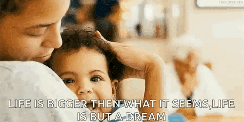 a woman is holding a baby in her arms with a quote that says life is bigger than what it seems