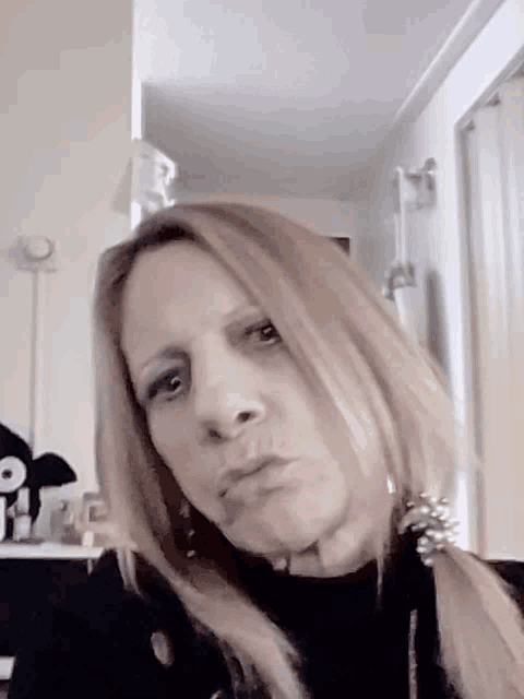 a woman is making a funny face in a room