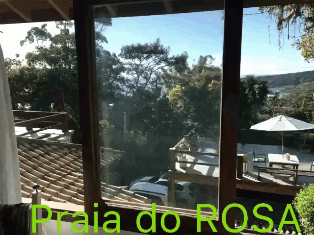 a window with the words praia do rosa written above it