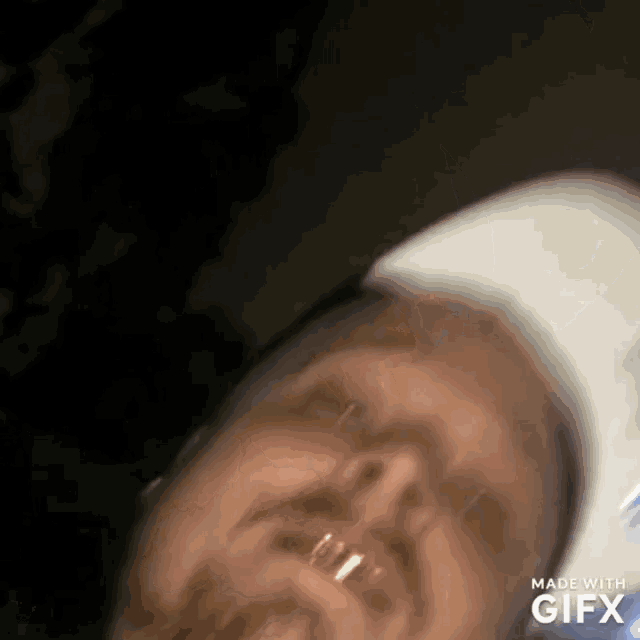a close up of a man 's face with the words made with gifx below it