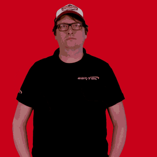 a man wearing a hat and glasses is wearing a black shirt that says bart-tek