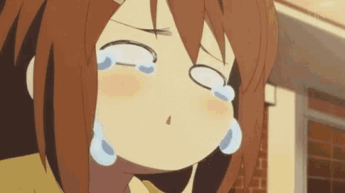 a close up of a girl crying with tears coming out of her eyes