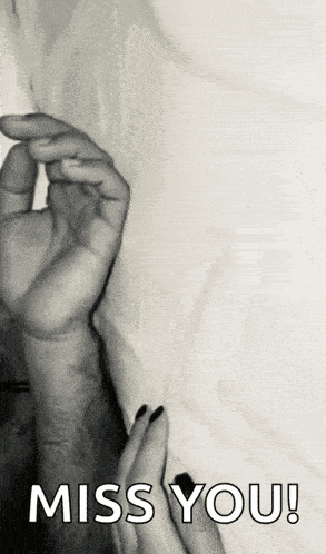 a black and white photo of a person holding another person 's hand with the words `` miss you '' written on it .