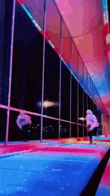 a person standing in front of a building with a reflection of a person in the window