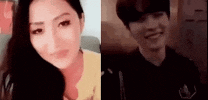 a woman and a man are sitting next to each other on a couch and smiling .