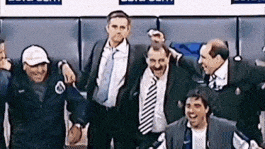 a group of men are standing next to each other in a locker room and laughing .