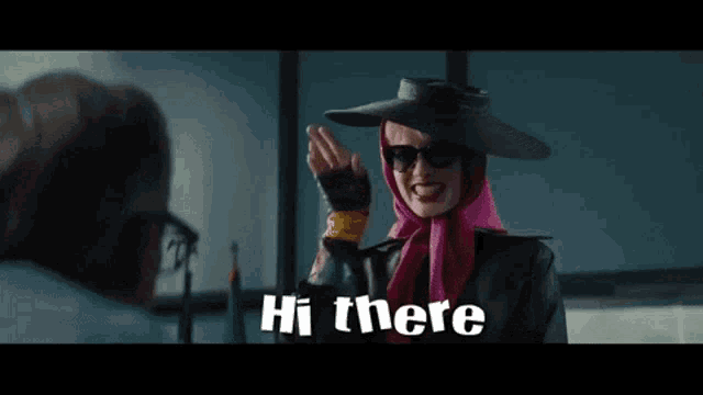 a woman wearing a hat and sunglasses says hi there .