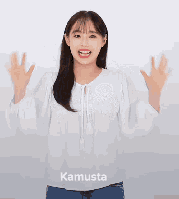 a woman wearing a white blouse with kamusta written on the bottom