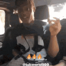 a man is smoking a cigarette in a car .
