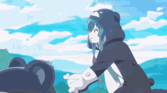 a girl in a teddy bear costume is holding a black bear