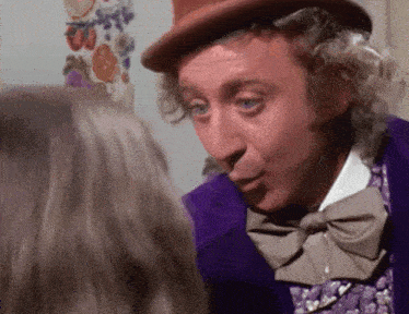 a man in a top hat and bow tie is talking to a woman