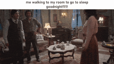 two men and a woman in a living room with a caption that says me walking to my room to go to sleep goodnight