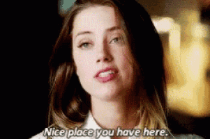 a close up of a woman 's face with the words `` nice place you have here '' .