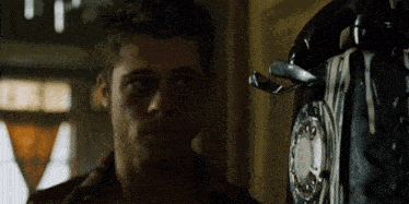 a man stands in front of a telephone that has the number 2 on it