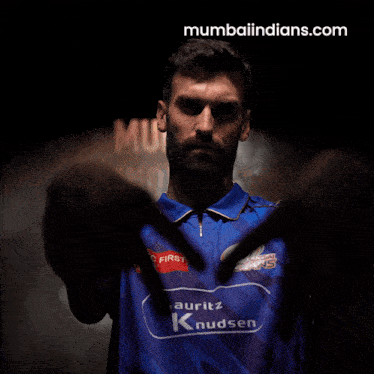 a man wearing a blue shirt with the word indians on it