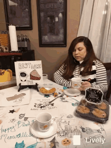 a woman sits at a table with a sign that says " best damn pie "