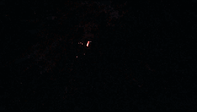 a fireworks display in the night sky with red and white fireworks