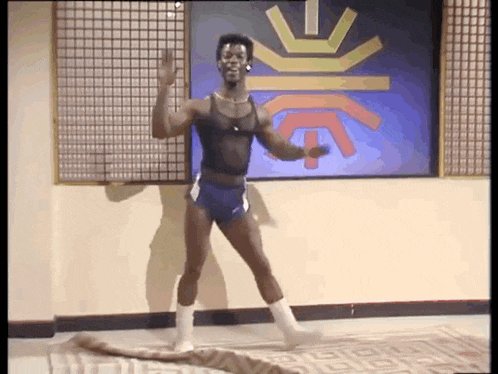 a man in shorts and white socks is dancing in a room