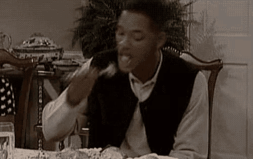 a man is sitting at a table with a plate of food in front of him .