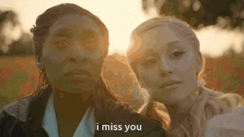 a couple of women standing next to each other with the words i miss you written below them