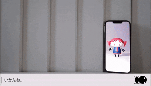 a phone with a cartoon character on the screen and a foreign language on the bottom right
