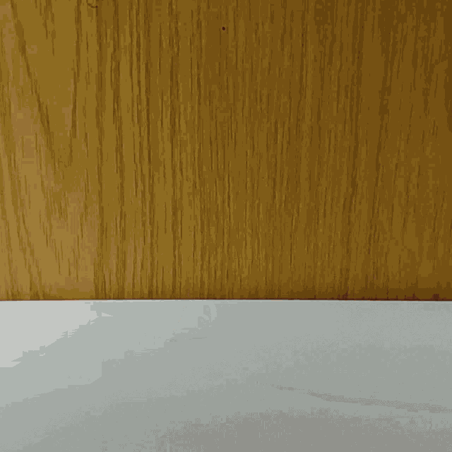 a person 's finger is reaching for a white soccer ball
