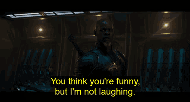 a man with a sword in his hand says you think you 're funny but i 'm not laughing